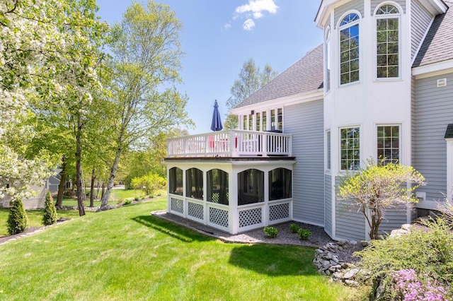 21 Hawk Ridge Rd, Meredith, NH 03253 - rear view of house with a lawn, a sunroom, roof with shingles, and a balcony