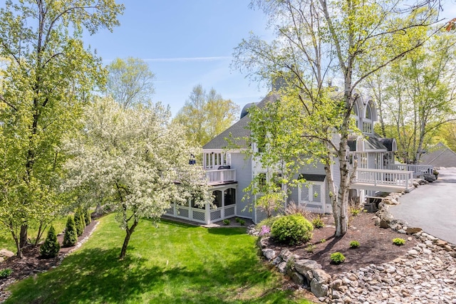 21 Hawk Ridge Rd, Meredith, NH 03253 - rear view of property with a lawn, a balcony, and a shingled roof