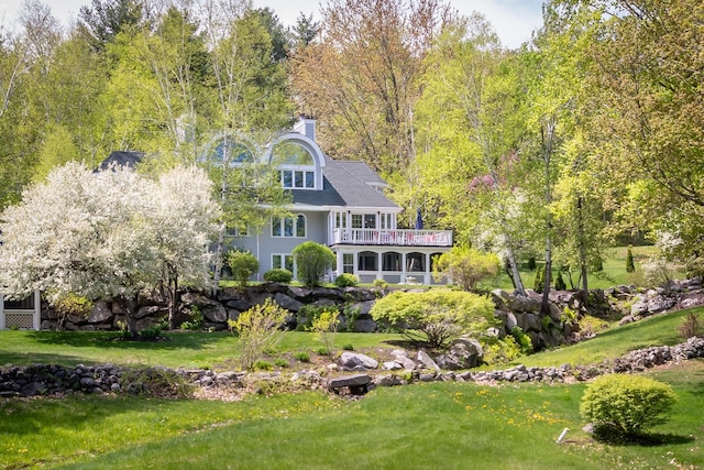 21 Hawk Ridge Rd, Meredith, NH 03253 - back of house featuring a balcony and a lawn