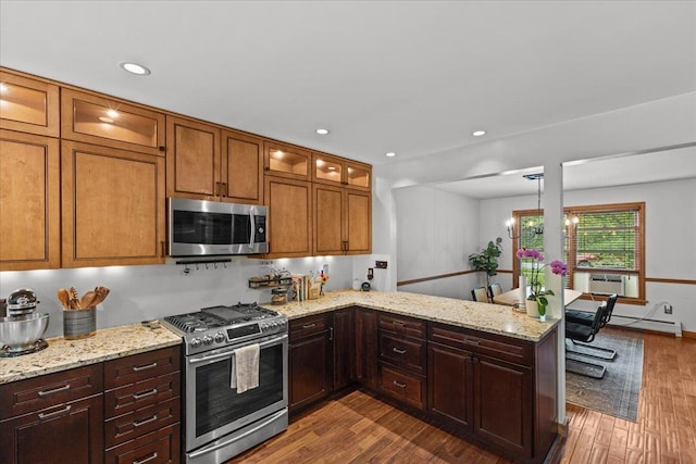 100 Maplewood Ave, Milton, VT 05468 - kitchen with appliances with stainless steel finishes, dark wood-type flooring, a peninsula, light stone counters, and recessed lighting