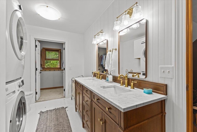 100 Maplewood Ave, Milton, VT 05468 - full bathroom featuring stacked washer and clothes dryer, double vanity, and toilet