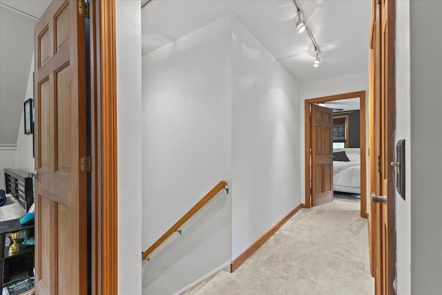 100 Maplewood Ave, Milton, VT 05468 - hall featuring an upstairs landing, light carpet, rail lighting, and baseboards