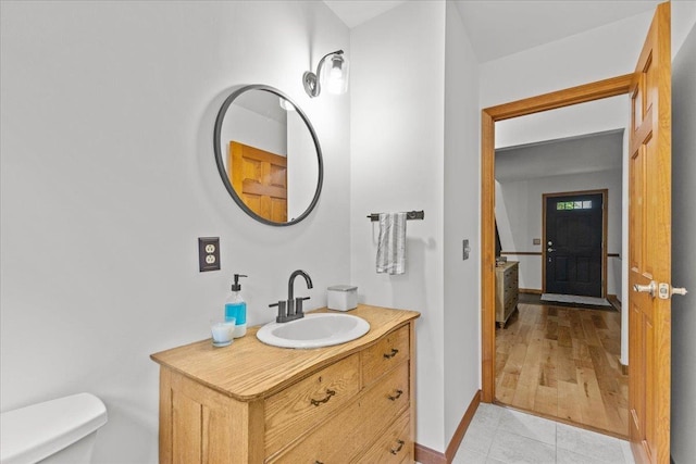 100 Maplewood Ave, Milton, VT 05468 - bathroom featuring vanity, toilet, baseboards, and tile patterned flooring