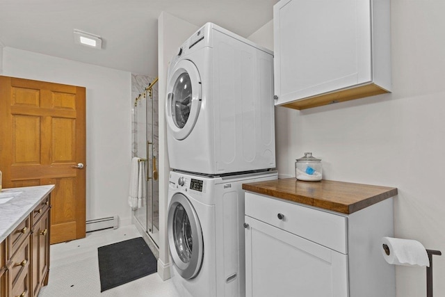100 Maplewood Ave, Milton, VT 05468 - laundry room with cabinet space, stacked washer / drying machine, and a baseboard radiator