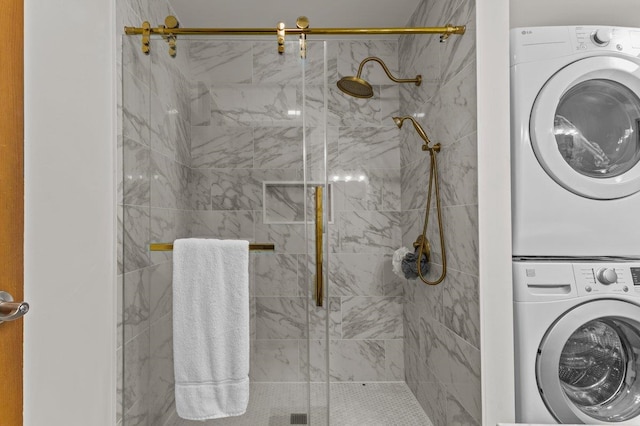 100 Maplewood Ave, Milton, VT 05468 - bathroom featuring stacked washing machine and dryer and a marble finish shower