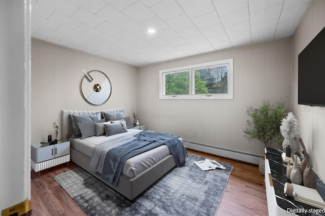 1572 Stowe Hollow Rd, Stowe, VT 05672 - bedroom with a baseboard heating unit and wood finished floors