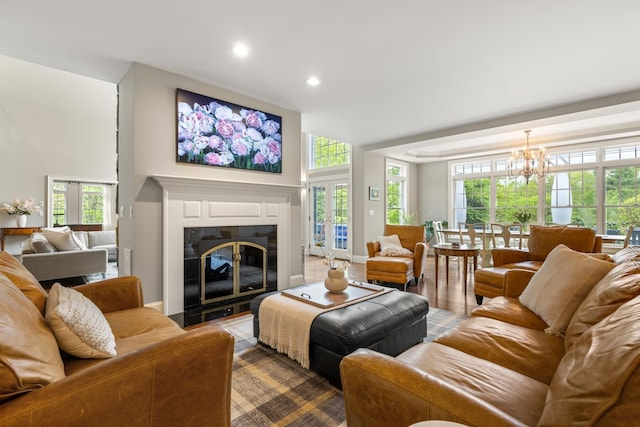 34 Orchard Hill Rd, Greenland, NH 03840 - living room featuring a chandelier, a fireplace with flush hearth, recessed lighting, and dark wood-type flooring