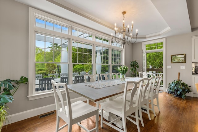 34 Orchard Hill Rd, Greenland, NH 03840 - dining area with a chandelier, wood finished floors, baseboards, and a raised ceiling