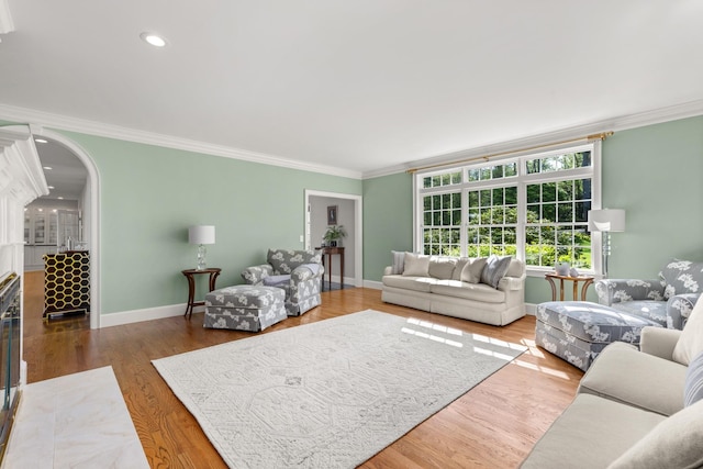 34 Orchard Hill Rd, Greenland, NH 03840 - living room with crown molding, arched walkways, baseboards, wood finished floors, and recessed lighting
