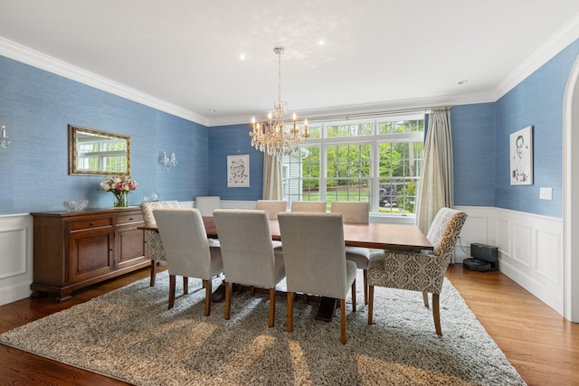 34 Orchard Hill Rd, Greenland, NH 03840 - dining room featuring wallpapered walls, a chandelier, ornamental molding, wood finished floors, and wainscoting