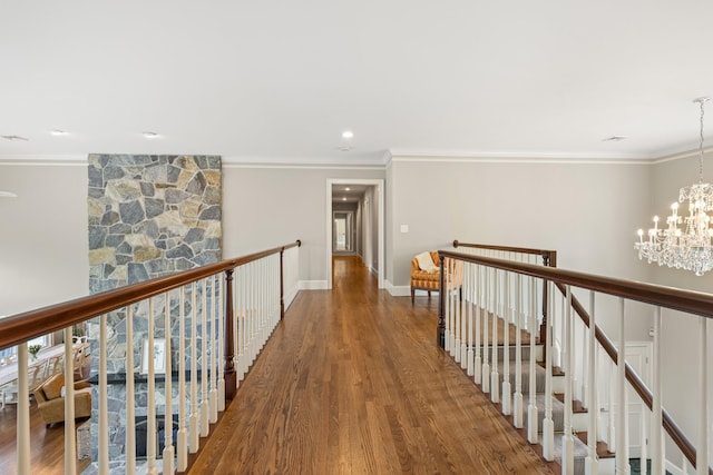 34 Orchard Hill Rd, Greenland, NH 03840 - corridor with an upstairs landing, a chandelier, ornamental molding, wood finished floors, and baseboards