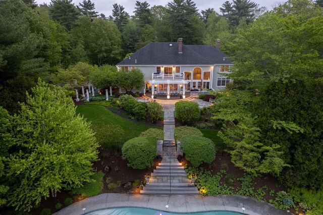 34 Orchard Hill Rd, Greenland, NH 03840 - back of property with stairs, a balcony, a patio, a chimney, and an outdoor pool