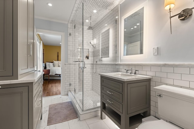 34 Orchard Hill Rd, Greenland, NH 03840 - ensuite bathroom featuring vanity, tile walls, ornamental molding, a stall shower, and toilet
