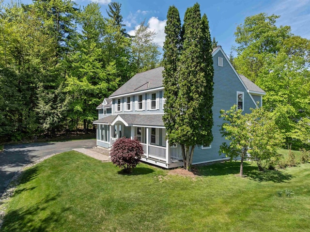 12 Drew Ln, Laconia, NH 03246 - view of front facade featuring a porch, a front yard, roof with shingles, and asphalt driveway
