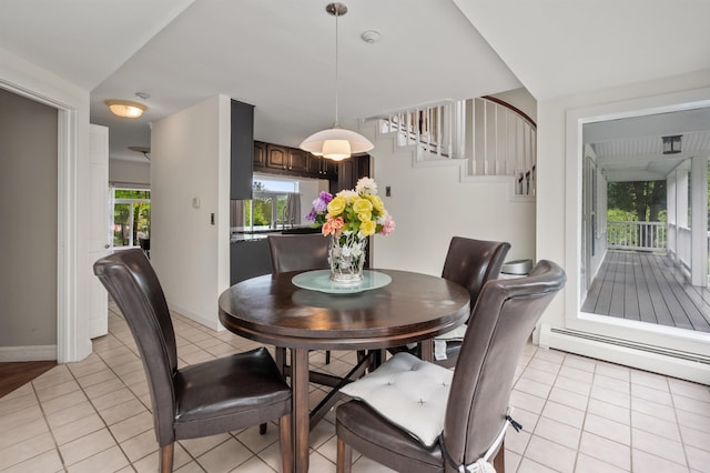12 Drew Ln, Laconia, NH 03246 - dining area featuring baseboard heating, light tile patterned flooring, stairs, and baseboards