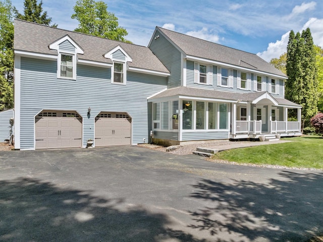 12 Drew Ln, Laconia, NH 03246 - view of front facade featuring driveway, an attached garage, a shingled roof, covered porch, and a front yard