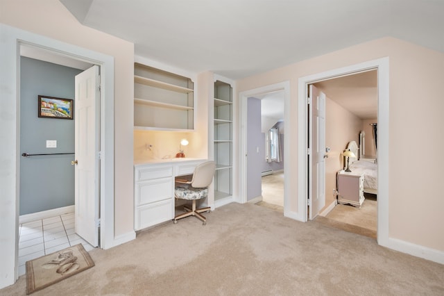 12 Drew Ln, Laconia, NH 03246 - home office featuring light colored carpet, built in desk, a baseboard heating unit, baseboards, and built in features