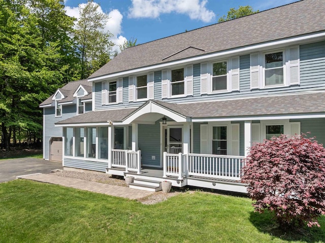 12 Drew Ln, Laconia, NH 03246 - view of front of house featuring a porch, a shingled roof, a garage, driveway, and a front yard