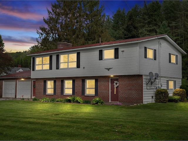 37 Dickinson Dr, Northfield, VT 05664 - view of front facade featuring an attached garage, a lawn, a chimney, and brick siding