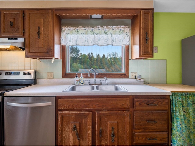 37 Dickinson Dr, Northfield, VT 05664 - kitchen featuring under cabinet range hood, a sink, appliances with stainless steel finishes, light countertops, and brown cabinetry