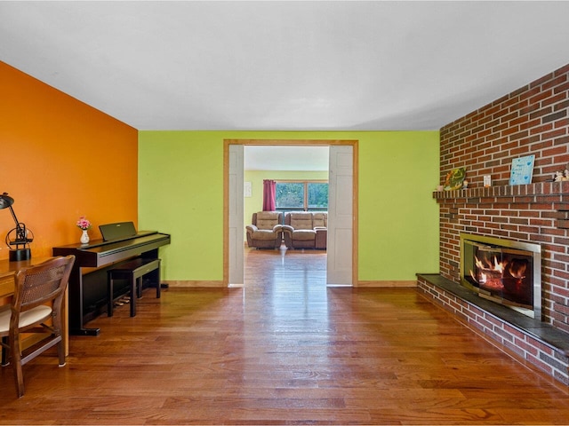 37 Dickinson Dr, Northfield, VT 05664 - living room featuring wood finished floors, a fireplace, and baseboards
