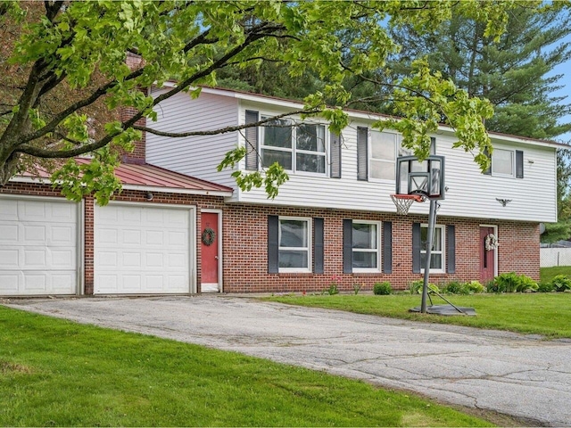37 Dickinson Dr, Northfield, VT 05664 - view of front of property with brick siding, driveway, a front lawn, and a garage