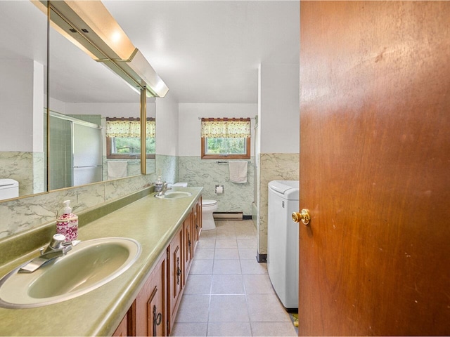 37 Dickinson Dr, Northfield, VT 05664 - bathroom featuring toilet, double vanity, washer / dryer, an enclosed shower, and tile patterned flooring