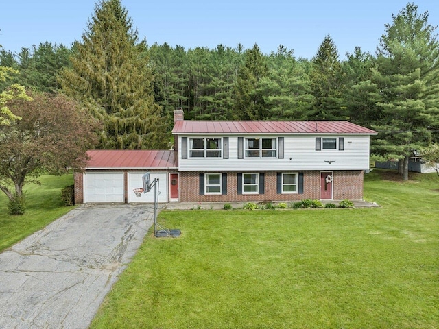 37 Dickinson Dr, Northfield, VT 05664 - view of front facade featuring an attached garage, brick siding, driveway, a front yard, and a chimney