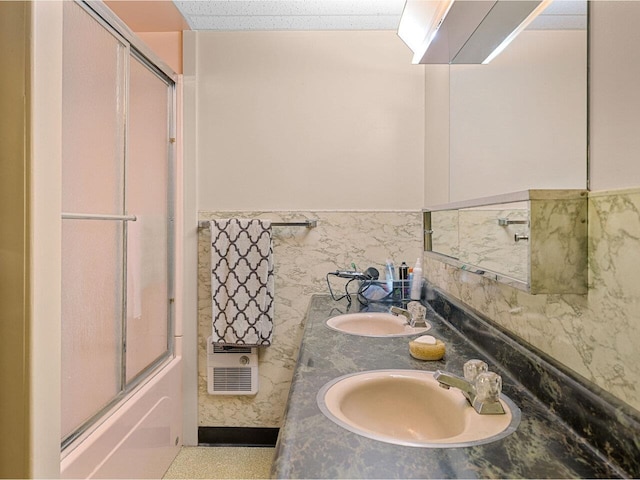 37 Dickinson Dr, Northfield, VT 05664 - full bathroom featuring double vanity, a wainscoted wall, combined bath / shower with glass door, and heating unit