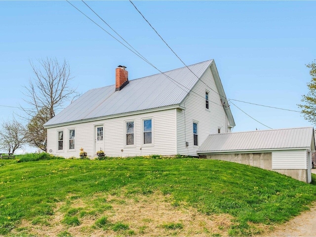183 Morrie Rd, Washington, VT 05675 - view of side of property with a chimney, metal roof, and a yard