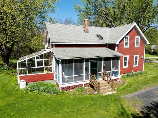 825 S End Rd, North Hero, VT 05457 - back of property featuring a sunroom, a shingled roof, a chimney, and a yard