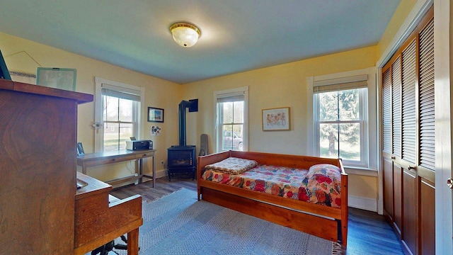 825 S End Rd, North Hero, VT 05457 - bedroom with wood finished floors, multiple windows, and a wood stove