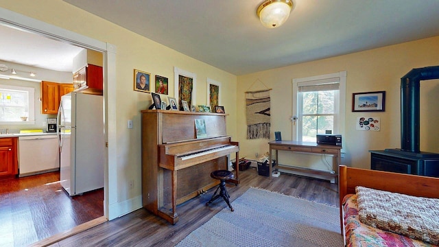 825 S End Rd, North Hero, VT 05457 - home office with dark wood-style floors, a wood stove, and baseboards