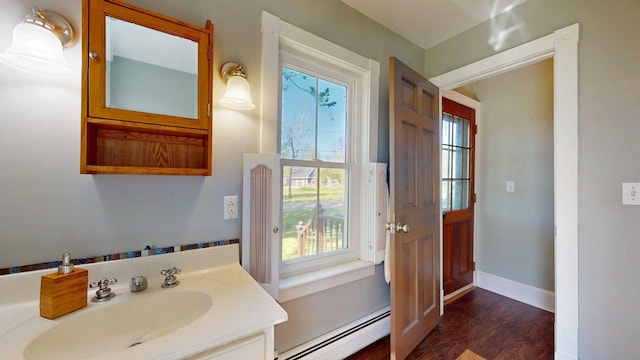 825 S End Rd, North Hero, VT 05457 - bathroom featuring a baseboard heating unit, plenty of natural light, vanity, and wood finished floors