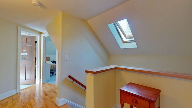 825 S End Rd, North Hero, VT 05457 - staircase featuring a skylight, wood finished floors, vaulted ceiling, and baseboards