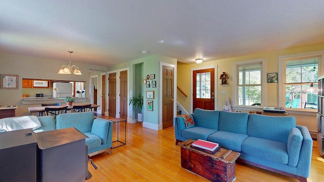825 S End Rd, North Hero, VT 05457 - living room with a chandelier, light wood-style flooring, stairway, and baseboards