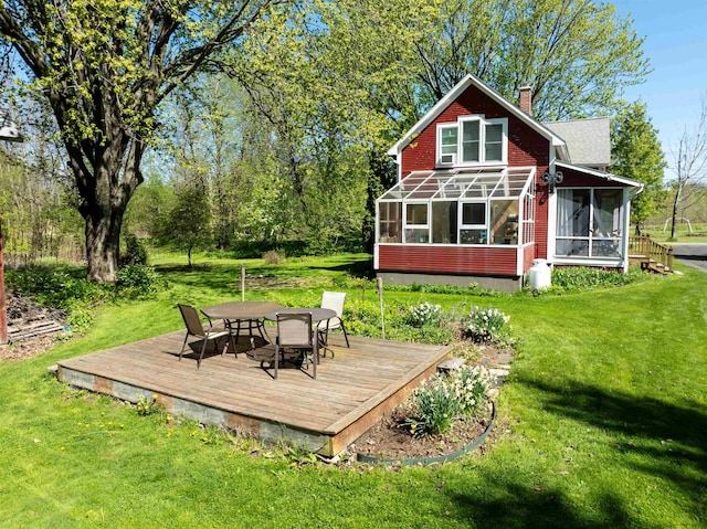 825 S End Rd, North Hero, VT 05457 - back of house featuring a sunroom, a wooden deck, a chimney, and a yard