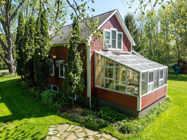 825 S End Rd, North Hero, VT 05457 - view of property exterior with a sunroom, a yard, and a playground