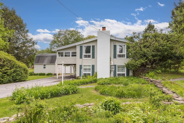 18 Riverdale Ave, Dover, NH 03820 - view of front of property featuring driveway, a chimney, and an attached carport