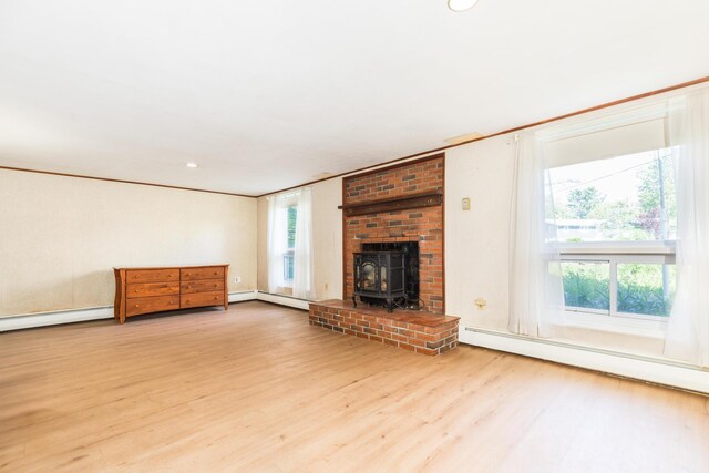 18 Riverdale Ave, Dover, NH 03820 - unfurnished living room featuring baseboard heating, wood finished floors, a wood stove, and recessed lighting