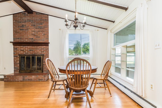 18 Riverdale Ave, Dover, NH 03820 - dining space featuring a chandelier, light wood-style floors, baseboard heating, and a fireplace