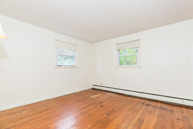 18 Riverdale Ave, Dover, NH 03820 - spare room featuring baseboard heating, plenty of natural light, wood-type flooring, and baseboards