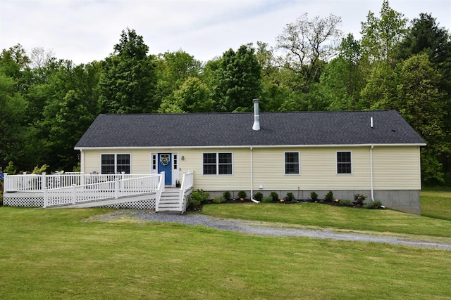 3900 Jersey St, Panton, VT 05491 - view of front facade with a wooden deck, a front yard, and a shingled roof