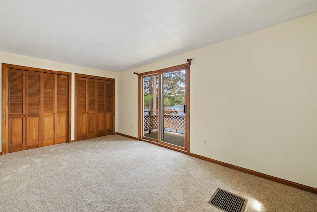 34 Winter Hill Ln, Andover, NH 03216 - unfurnished bedroom featuring access to outside, multiple closets, baseboards, and carpet flooring