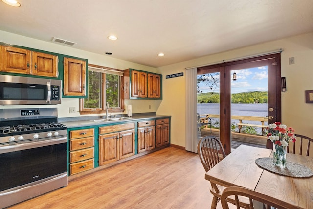 34 Winter Hill Ln, Andover, NH 03216 - kitchen with stainless steel appliances, a sink, brown cabinetry, light wood finished floors, and recessed lighting