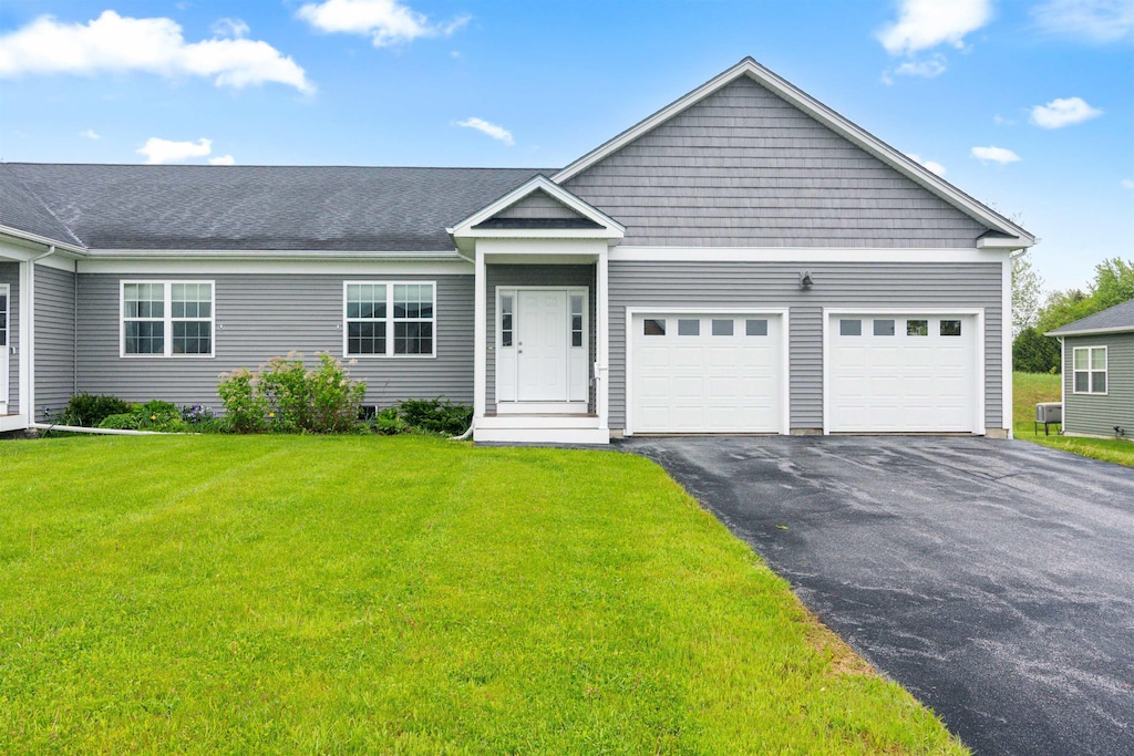 14 Paige Rd, Fairfax, VT 05478 - ranch-style home with driveway, an attached garage, and a front lawn