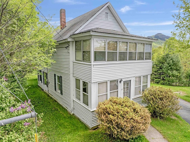 25 Eames St, Northumberland, NH 03582 - view of home's exterior with a chimney, roof with shingles, and a lawn