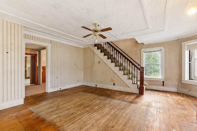 25 Eames St, Northumberland, NH 03582 - unfurnished living room with hardwood / wood-style floors, ceiling fan, stairway, baseboards, and wallpapered walls