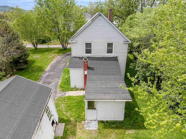 25 Eames St, Northumberland, NH 03582 - rear view of house featuring a chimney, a lawn, and an outbuilding