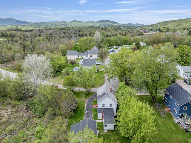 25 Eames St, Northumberland, NH 03582 - aerial overview of property's location featuring a heavily wooded area, a mountainous background, and nearby suburban area